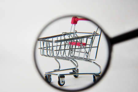 Online shopping concept. Magnifying glass and shopping cart on white background. Product searchの写真素材