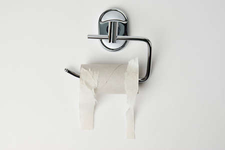 Empty toilet paper roll holder, background with copy space, close-up