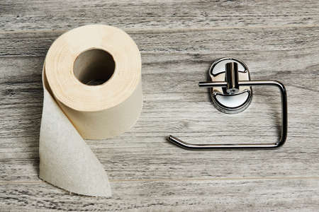 Empty toilet paper roll holder, background with copy space, close-up
