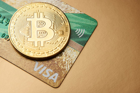 Bitcoin and Visa credit card. Visa card and bitcoin cryptocurrency payment concept. Perm, Russia -...