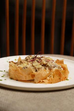 Fried shrimps and mushrooms with creamy cheese sauce