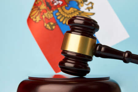 Sanctions in Russia concept. Flag of Russia and judge gavel on blue background, close-upの写真素材