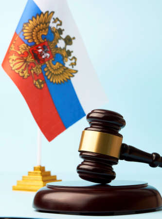 Sanctions in Russia concept. Flag of Russia and judge gavel on blue background, close-upの写真素材