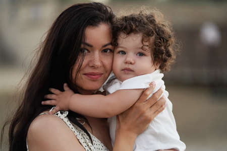 Mother and daughter having fun. Happy loving mother and baby, outdoors portraitの写真素材