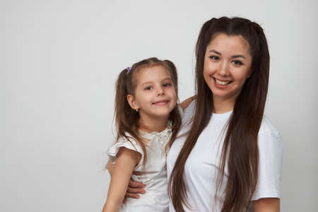 Happy woman and child girl 5-6 years old having fun. Young mother with little daughter portrait on...
