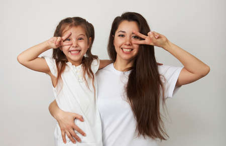 Happy woman and child girl 5-6 years old having fun. Young mother with little daughter portrait on...