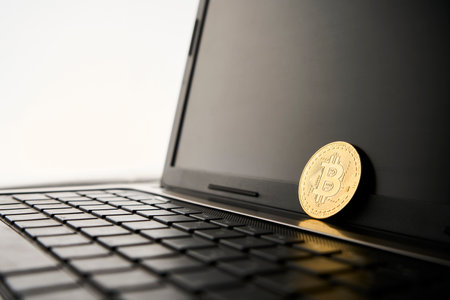Bitcoin and laptop computer, close-up. Cryptocurrency coin, virtual money. Gold Bitcoin digital currencyの写真素材