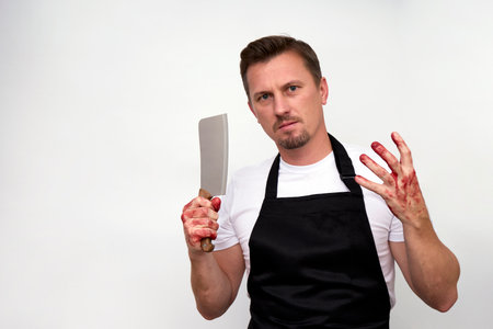Young man with bloody hands holding axe. Male chef with kitchen knife isolate on white background...