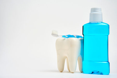 Dental oral hygiene concept. A toothbrush with toothpaste and oral rinse on white background with copy space, close-up. Healthy teethの写真素材