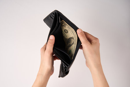 Hands holding wallet with coins money on white background. Financial crisis and bankruptcy concept