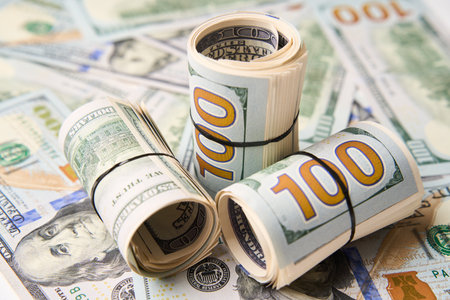 Roll of hundred dollar bills. Money roll on white background
