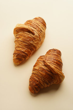 Traditional french croissant on pastel background with copy spaceの写真素材