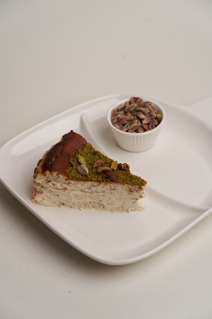 Pistachio cheesecake on a white background with copy space, close-upの写真素材