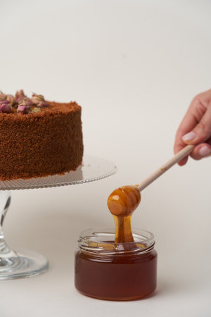 Chocolate honey cake on a white background, close-upの写真素材