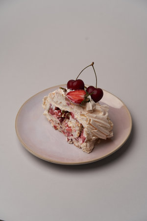 Meringue Pavlova cake with fresh strawberry and cherry