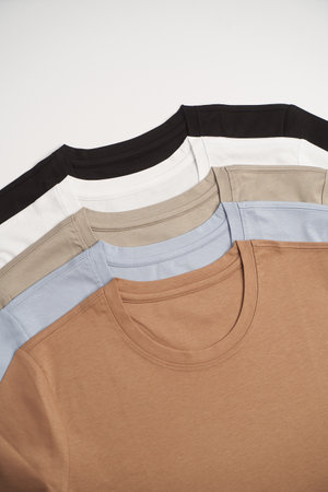 Colorful t-shirt collection on white background with copy space, close-upの写真素材