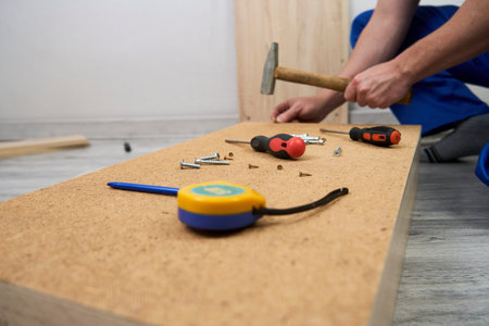 Professional furniture assembly and repair concept. Contractor repairman assembling furniture, indoorsの写真素材