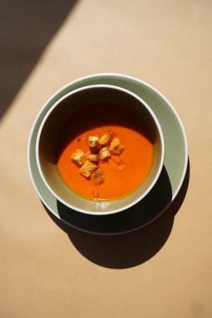 Tomato soup in a bowl close-up, background with copy spaceの写真素材