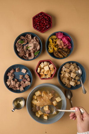 Traditional khash soup with snacks. Boiled cow stomach and tongue as caucasian gourmet foodの写真素材