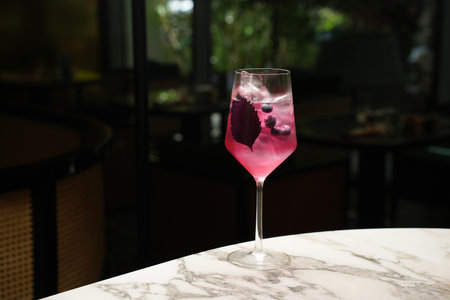 Fresh cocktail glass on a marble bar table. Alcohol cocktail drink, close-up. Modern alcoholic...