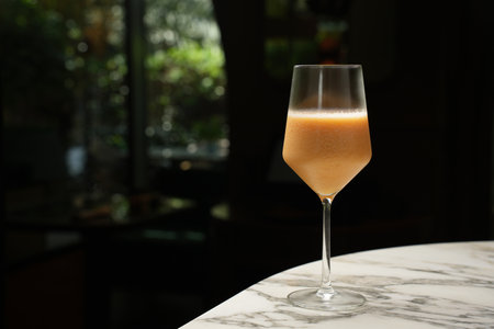 Fresh cocktail glass on a marble bar table. Alcohol cocktail drink, close-up. Modern alcoholic beverageの写真素材