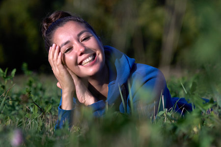 Happy woman enjoying freedom outdoors. Young woman walking in field in fieldの写真素材