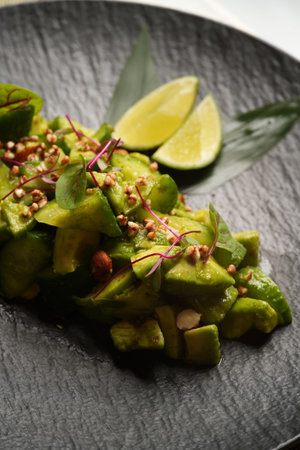 Avocado salad with fresh cucumber almond, close-up. Healthy vegetarian salad and detox diet food