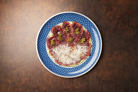 Sliced beef and avocado with grated cheese. Healthy diet food
