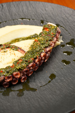 Grilled octopus with mashed potatoes and pesto sauceの写真素材