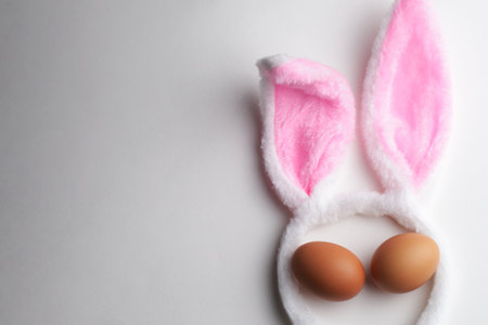 Bunny ears and chicken eggs on a white background with copy space. Happy Easter holiday conceptの写真素材