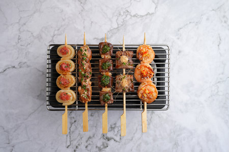 Yakitori and kushiyaki skewered meat. Traditional Japanese kebab on grill.の写真素材