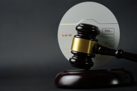 Music copyright law concept. CD compact disc and judge gavel background with copy-space. Music piracy and owners rightsの写真素材