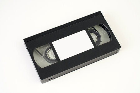 Video cassette tape on white background, close-up. Retro analog tape VHS cassette