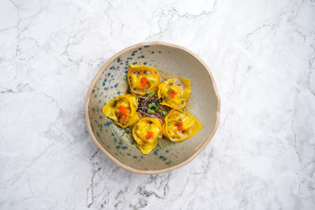 Wontons bowl or dumpling, traditional oriental food, marble background with copy space, top view