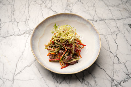 Veal salad with vegetables and teriyaki. Sliced meat and vegetables salad in a white bowlの写真素材