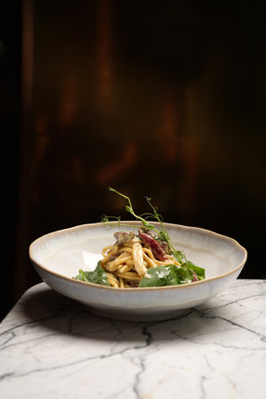 Italian fettuccine pasta in creamy sauce with meat and vegetablesの写真素材