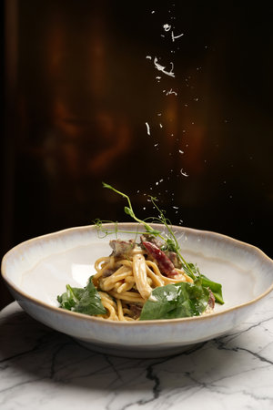 Italian fettuccine pasta in creamy sauce with meat and vegetablesの写真素材