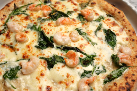 Italian shrimp pizza. Pizza with shrimps, herbs and cheese on a white plateの写真素材