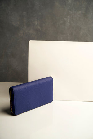 Leather clutch bag or purse on a gray background, close-upの写真素材