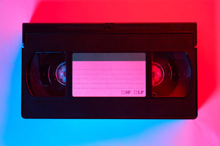 Videocassette with a pink label on a red background
