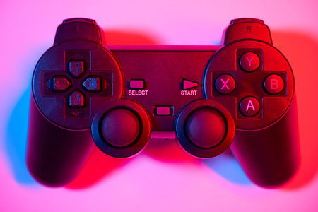 Game controller, video game joystick or gamepad control on a colorful background, close-up