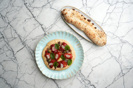 Hummus with baked vegetables, chestnut and pita breadの写真素材