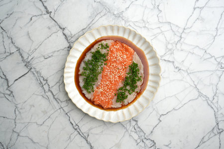 Tartare with salmon, tuna and sesame in sauceの写真素材