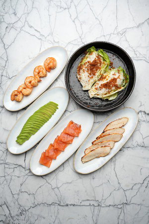 Lettuce salad with shrimps, avocado, salmon and chicken breastの写真素材