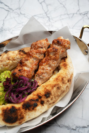 Chicken lula kebab with vegetables and pita breadの写真素材