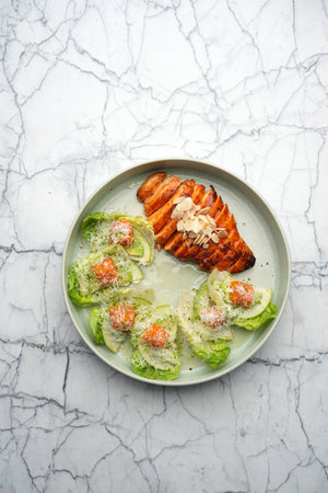 Smoked chicken breast with salad leaves, avocado and cheeseの写真素材