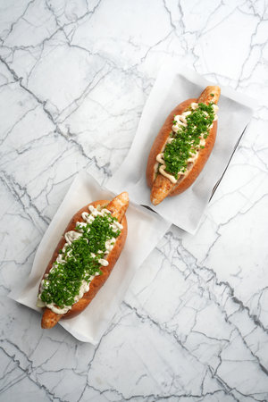 Hot dog with chicken sausage, green onion and sauceの写真素材