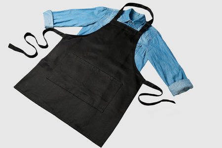 Black and blue apron and shirt isolated on a white background.