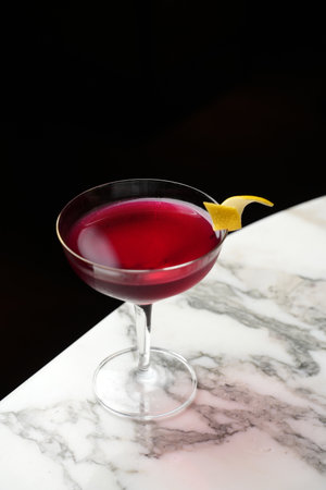 Cosmopolitan Martini cocktail glass on a marble table background with copy space, close-upの写真素材