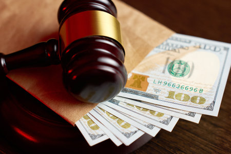Judges Gavel and American dollar money on a wooden table background with copy space, close-up. Judgement money and justice concept. Auction and bribeの写真素材